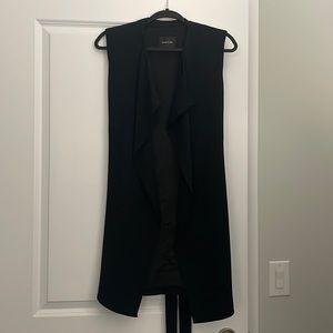 Long vest, can be worn over dresses, leggings and pants. Good layering piece.